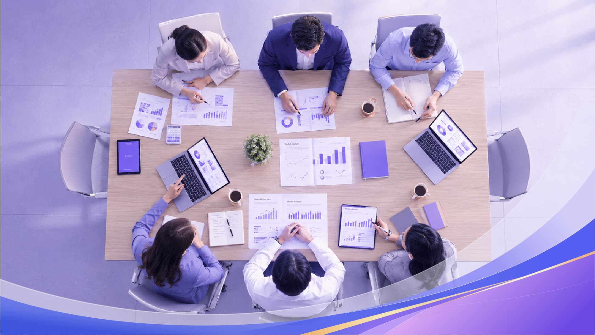 Business team reviewing performance data around a conference table